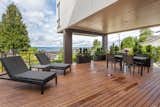 The expansive deck connecting the living spaces to the outdoor is also partially covered by the cantilevered upper volumes creating intimate space and providing protection from the elements.