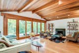 Living Room, Ceiling Lighting, Chair, Light Hardwood Floor, Wood Burning Fireplace, and Medium Hardwood Floor  Photo 8 of 29 in The Shutter House by Signature Sotheby's