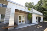 Exterior, Flat RoofLine, Beach House Building Type, Wood Siding Material, Glass Siding Material, Metal Siding Material, Shed RoofLine, House Building Type, and Metal Roof Material Seating at entrance  Photo 17 of 18 in The Summer House by Azin Valy