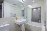 Bathroom that used to be an air shaft- the uncovered window openings were maintained as an homage to the history of the old tenement apartment buildings that existed. 