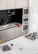 The kitchen features stainless steel laminate countertops that reflect light throughout the day