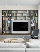  The materials used—smoked oak, black iron, stainless steel laminate, and brass—were chosen to mirror the colors of the sunrise and sunset light that floods the apartment.