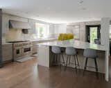 A large, bright kitchen featuring a triangular island and ample space for cooking