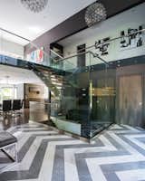Main stairs with glass railing allowing for natural lighting