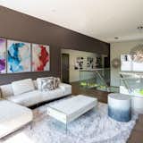 A loft-style seating area featuring glass railing 