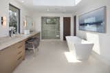 Spa-style Master Bath featuring Italian Travertine Slabs, Limestone Floors, and a Remote-Controlled Skylight