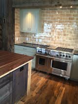 Reclaimed Barn Wood Flooring and Distressed Oak wood details, Pratt and Lambert Italian ceramic back splash tile, 48" Wolf Range