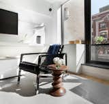 Living Room, Rug Floor, Media Cabinet, Storage, Chair, Desk, Table Lighting, and Light Hardwood Floor Living Room  Photo 5 of 10 in Upper East Side by Elvan Arolat