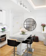 Kitchen, Marble Counter, Light Hardwood Floor, White Cabinet, and Ceramic Tile Backsplashe Open Kitchen  Photo 8 of 10 in Upper East Side by Elvan Arolat