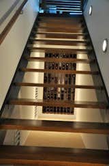 Staircase, Wood Tread, Metal Tread, Metal Railing, and Wood Railing Open staircase to basement with build in wine rack  Photo 17 of 19 in Crow Hill Farm by Thomas Paron