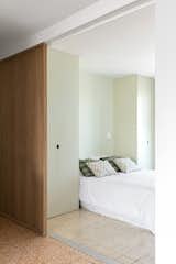 The bedroom opens onto living areas through a custom made sliding wooden door