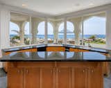 A large island and counter seating can be found inside the gourmet kitchen, which is located adjacent to the dining area, all part of the convivial great room. 