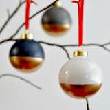 Add a glimmer of gold to your Christmas tree with these modern, two-tone Christmas ornaments. Base colors of trendy black and white give way to timeless gold on these beautiful baubles.