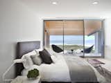 Bedroom, Table Lighting, Recessed Lighting, Travertine Floor, Ceiling Lighting, Night Stands, and Bed  Christin Perry’s Saves from Long Island Modern Beach House