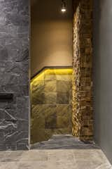The Column which are seen and enveloped opposite to every landing of stair is designed up in Rustic style and made of rough wooden small squares in 3D style wrapping up amazingly. And the wall connecting to the stair is also designed and made up very uniquely with the usage of many different industrial materials