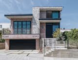 A subtle hand painted calligraphy print is featured along the exterior of the home and continues into the inside. Matte black accented windows and garage door create a sexy and sleek look.
