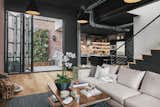  A second set of bifold doors open up to the wrap around patio and eat in bar area. Exposed HVAC ducts lend to the industrial feel leading into the kitchen. 