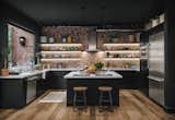An exposed brick wall adds an architectural centerpiece in the kitchen. The island and countertops feature Carrara marble.