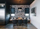 Black accents continue in the dining area with black leather Eames style dining chairs and sheer black shades.