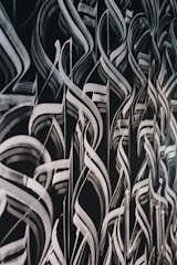 A similar hand painted calligraphy print from the exterior continues into the dining area.