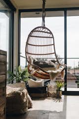 A Blucher rattan swing chair adds a Bohemian flare in the master bedroom. 