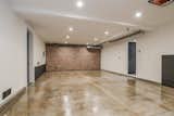 Exposed brick leads all the way down to the four-car garage on the bottom floor.