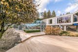 The side view of the home. The all glass atrium houses an indoor lap pool.