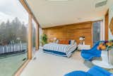 The master bedroom peers out to the beachfront and features a cedar wall.