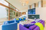 The bright colors continue into the living room. A grand three-chimney fireplace is the centerpiece of this space.
