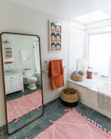 The master bathroom is filled with colorful textiles and quirky art.