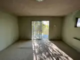 Before: The original primary bedroom had a small slider that opened to the deck. Wang and the owners wanted to keep the access to the outdoors while modernizing the space.