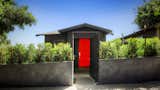 Mini House from its sloping street location. The ficus hedge will grow up to create an enclosed compound