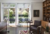 On the lower level, the new master bedroom takes advantage of the existing tall ceiling heights with a large expanse of windows and doors to visually connect to the garden and create a bright, airy space.