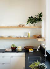 Floating shelving in the kitchen adds to the open and airy interior feel. 