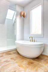 Bath Room, Freestanding Tub, Pendant Lighting, Porcelain Tile Floor, and Subway Tile Wall The tile floor was created using a digital reproduction of wood that has been crosscut sawn to showcase the growth rings.  Photo 6 of 11 in 1980s Makeover by Sarah Brown