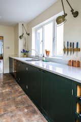 Flooring – Mandarin Stone
Sink – Stereo Single Bowl 650mm wide, Stainless Steel
Tap – Perrin & Rowe Ionian with Etruscan Spout Finish, Pewter
Sink Run: Arenastone Bianco Nuvolo
Wall lights (sink run) – Jielde, LOFT  Photo 13 of 15 in Green Industrial Style Galley Kitchen by UpSpring PR
