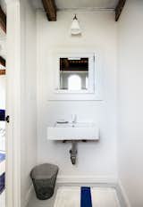 Powder room and sleeping loft, featuring the Hector Dome Wall Light from Original BTC
