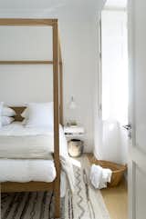 Their main bedroom is 1,100 square feet and features a four-poster bed from Natural Bed Company that draws the eye upward. To save bedside room, they decided on the early Modernist-style Task Wall Light from Original BTC. They chose Parachute’s Linen Duvet, as well as Linen & Me’s Euro Shams and Blanket, for a simple yet elegant aesthetic.