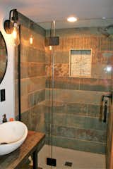 Bathroom with stone sink, rustic tiled shower