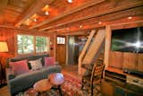Cozy living room with flat screen TV, gas fireplace, and original cabin touches