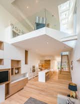 Daylight from the third floor skylights reach deep into one of the Relmar Houses by Lebel &amp; Bouliane, creating a bright, light-filled interior.