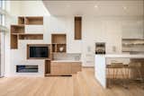 The kitchen in the income-property features a custom wood shelving unit and integrated storage.