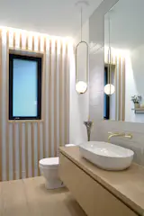 West Side Clerestory - Powder room continues the wood slat detail from the stairs.