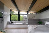 West Side Clerestory - Primary bedroom with vaulted ceilings, exposed beams, and an oversized window seat with storage below.