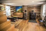 The living room is on the ground floor of the 1827 original footprint of the house and features chestnut logs and exposed ceiling joists.