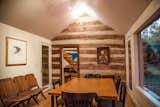 The dining room looking out onto towering maple trees and creek is a 1956 addition connected to the 1827 original structure.