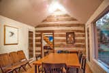 The dining room looking out onto towering maple trees and creek is a 1956 addition connected to the 1827 original part of the structure.