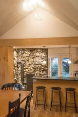 The dining room steps into the stone-walled kitchen, a 70's addition that opens out onto herb and perennial gardens.