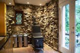 Artist Ozz Miller who lived at Ravenswyck for 48 years until his death in 2002 built the kitchen's stone walls which include cantilevered rock shelves.