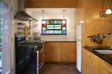 The renovated kitchen features a stained glass window created by artist Ozz Miller who was a resident of Ravenswyck for 48 years until his death in 2002.